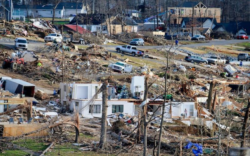 Natural Disater Tornado aftermath. Neighborhood of homes pumled to the ground. Homeowners cleanup.