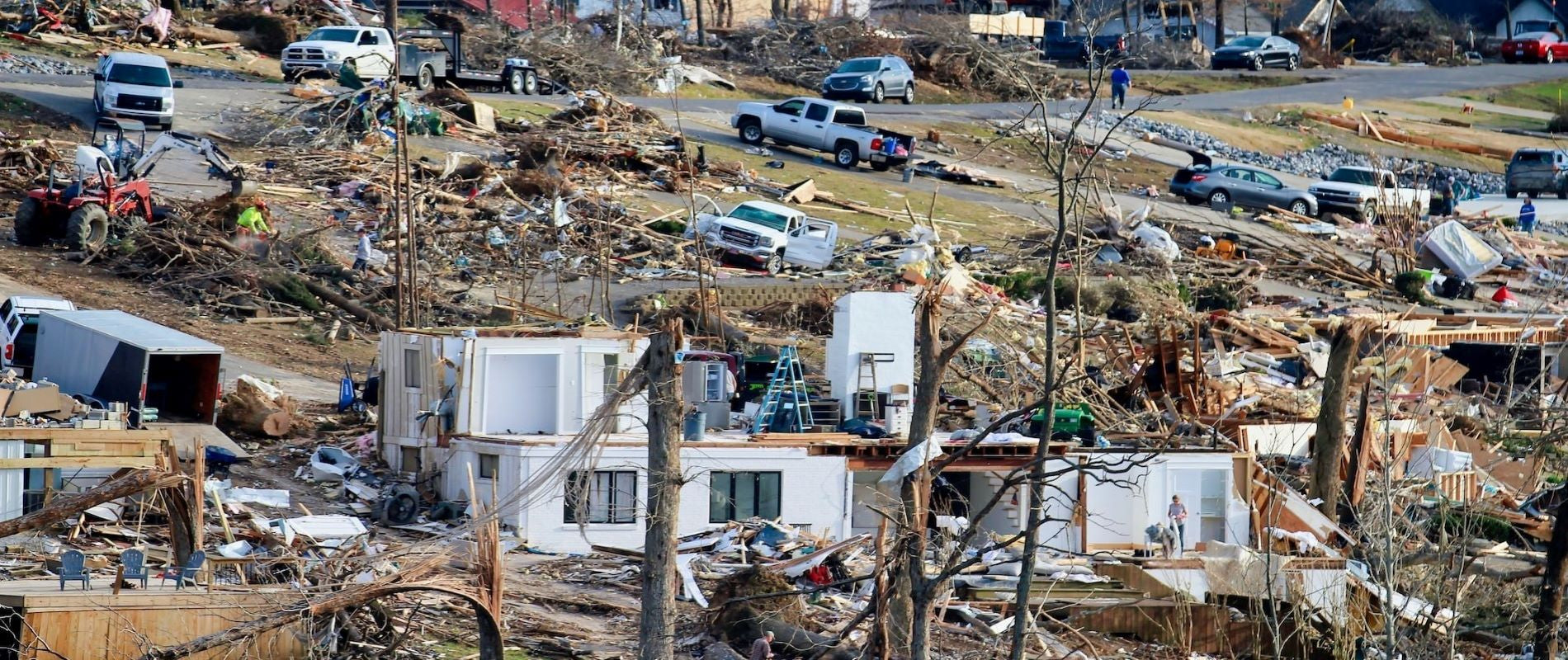 Natural Disater Tornado aftermath. Neighborhood of homes pumled to the ground. Homeowners cleanup.